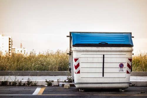 Professional waste removal truck collecting garden waste in Chiswick