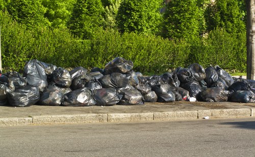 Customer loading a skip with waste